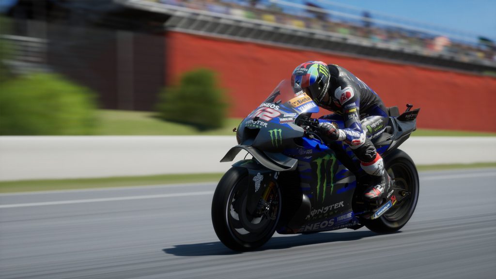 professional motorcycle racer leaning into a sharp turn on a track, showcasing intense speed and precision from MotoGP 24