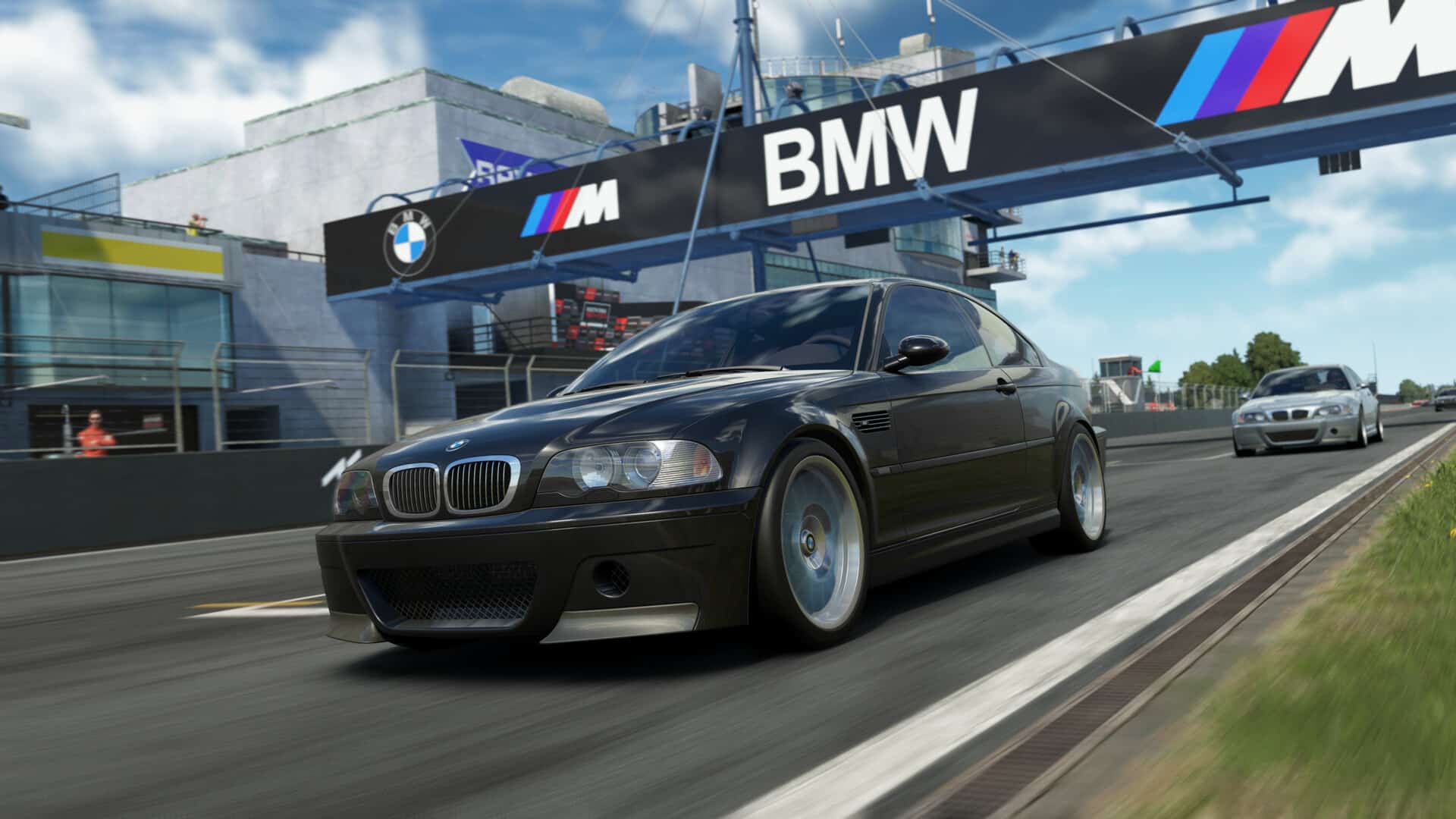 A realistic screenshot from the sim racing game Assetto Corsa EVO showing a black BMW M3 E46 CSL speeding down a race track, with a large BMW banner visible above the track.