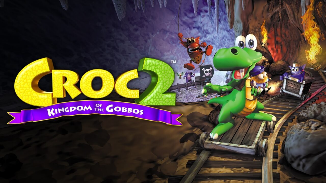 Croc 2 Kingdom of the Gobbos logo next to Croc riding a minecart through a cave, with Gobbos and a Dantini behind him