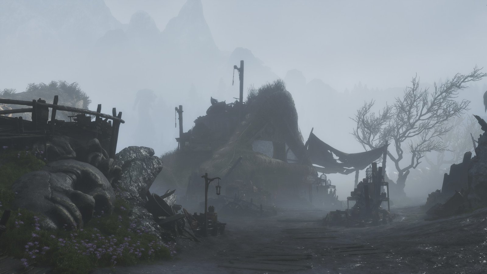 Fable: Sodden Dorrit Fable screenshot: a muddy track leads past thatched, ramshackle buildings and a bare tree in misty Sodden Dorrit