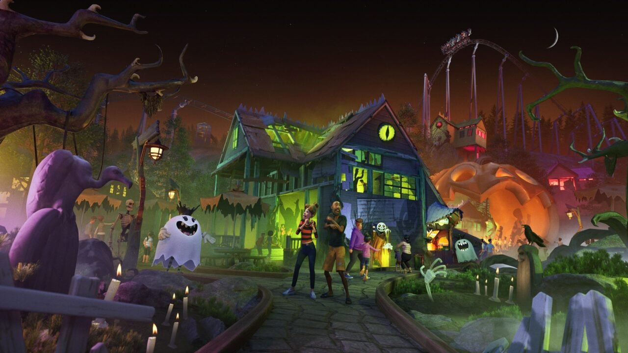 Park guests and a grinning ghost entertainer outside a glowing haunted house, with a giant pumpkin and a coaster behind them at night