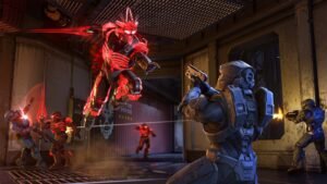 Halo Infinite screenshot: A red Elite leaping at a blue Spartan in a dimly lit room