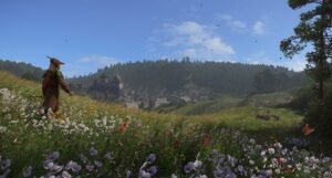 A lone traveller walking through a flower-filled meadow towards wooded hills