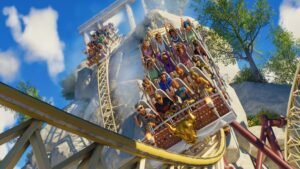 Riders throwing their arms up on a wooden rollercoaster
