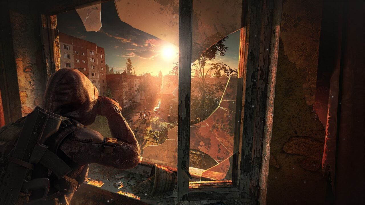 A hooded stalker crouches at a broken window, looking out over a sunlit, overgrown Zone town in S.T.A.L.K.E.R. 2: Heart of Chornobyl