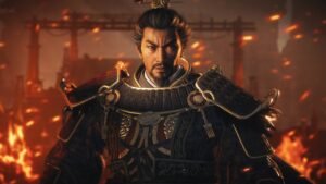 Wo Long 2: Wings of Ember screenshot: an armoured warlord standing in front of a burning gate